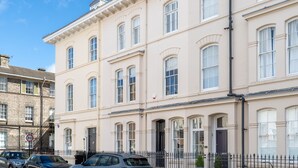 A multi-story building with a classic architectural style, featuring symmetrical windows and a central entrance. - The Classic on the Mount -  a premium stay that sleeps 4 guests  in 2 bedrooms (York)