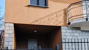 A building with a gated entrance, a small window, and a balcony with a metal railing. - Dwelling Euthymia a few minutes from Lake Como (Cosio Valtellino nr. 51)