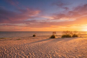 A beach with sand and sparse vegetation. - Freshly Updated Retreat at SeaShells – Easy Beach Access and Relaxed (Sanibel)