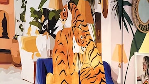 A room with a woven chair, a sofa, and a wall mural of a tiger. - Walk to Beach!「4 Bedroom」Vacation Home w Balcony! (Canals,)