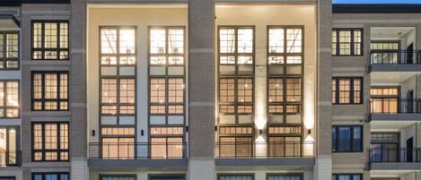 A multi-story building with large windows and balconies.
