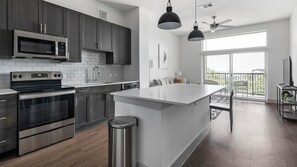 Fridge, dining tables - Landing | Stylish 1BD in Montopolis (Austin)