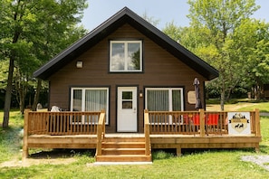 A lodge with a wooden exterior, a front porch, and a sign indicating it is a 'Luna Nuage' accommodation.