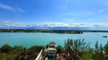 A resort with a pool, a gazebo, and a view of a large body of water.
