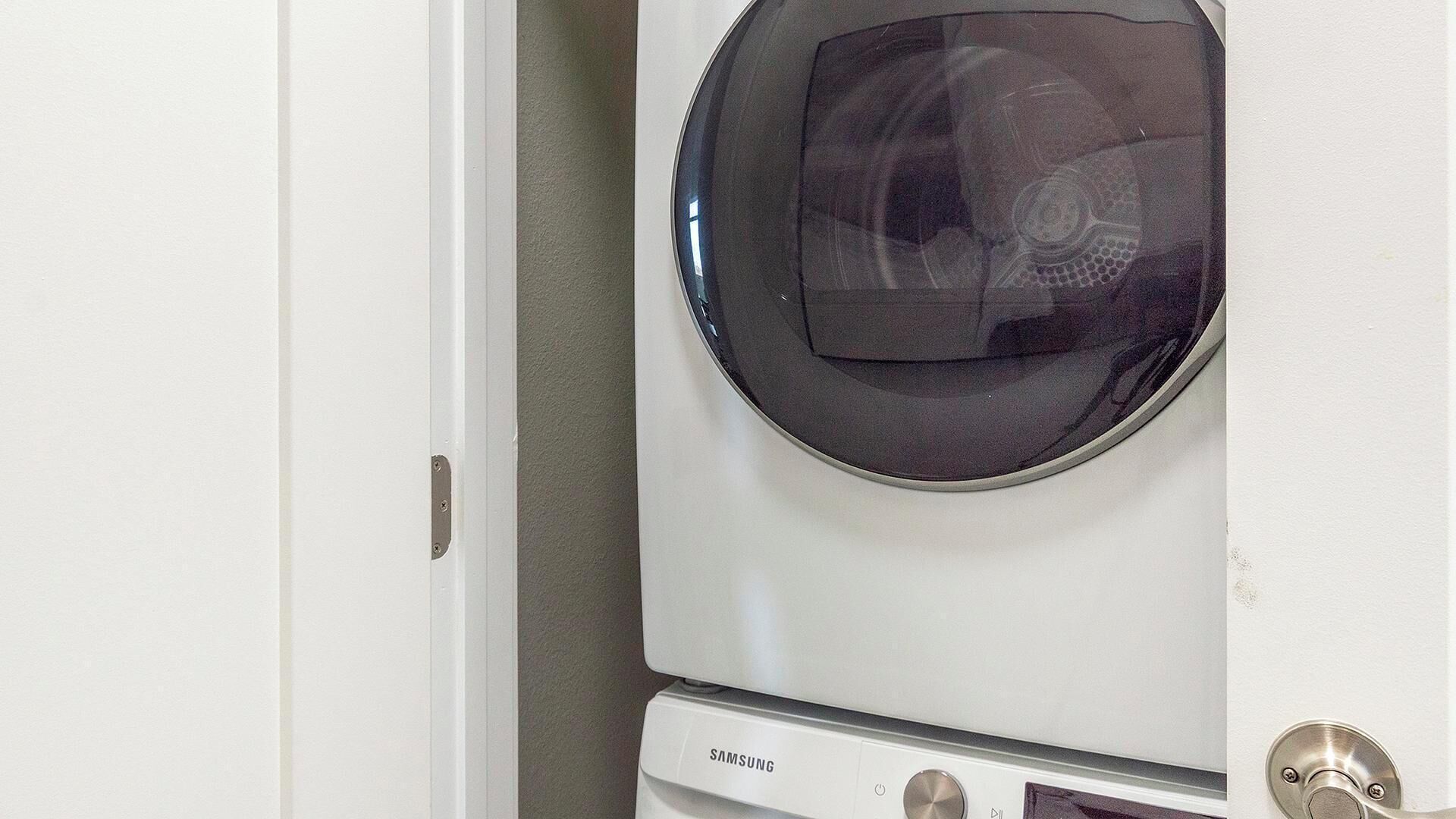 A white washing machine with a control panel and a door.
