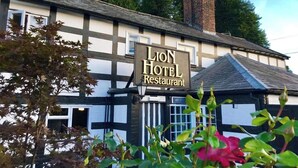 A traditional building with a sign reading 'Lion Hotel Restaurant.' - The lion hotel  (Berriew)