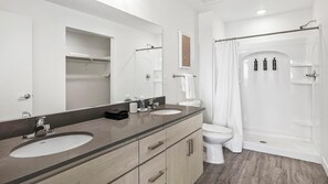 A modern bathroom with two sinks, a toilet, a shower, and a large mirror. - Landing | Incredible 2BD, Gym, Clubhouse (Mesa)
