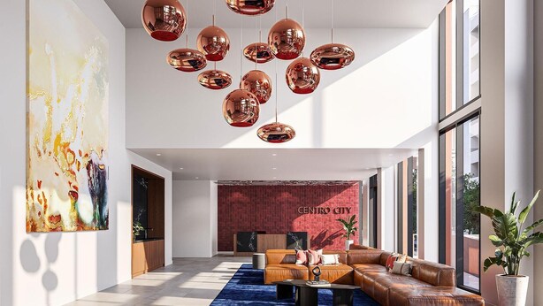 A spacious lobby with a leather sofa, a blue rug, and a red brick wall with 'CENTRO CITY' signage. - Landing | Incredible 1BD, Yoga Studio, Game Room (Miami)