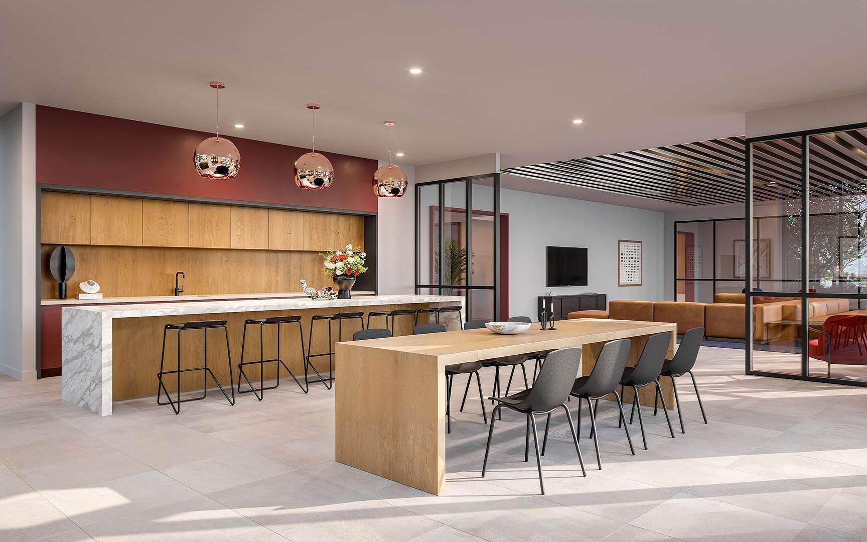 A modern kitchen with a central island, bar stools, and a dining area with chairs.