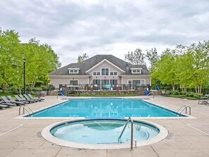 A swimming pool area with lounge chairs and a building in the background. - Landing | Incredible 2BD, Gym, Pool (King of Prussia)
