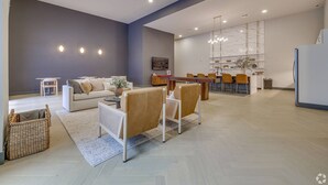 A spacious living area with a sofa, coffee table, and chairs, a dining area with a table and chairs, and a kitchen with a refrigerator. - Landing | Spectacular 1BD, Clubhouse (Tulsa)