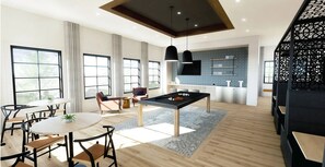 Un salon moderne comprenant une table de billard, un coin repas avec des chaises et un espace cuisine avec un téléviseur.