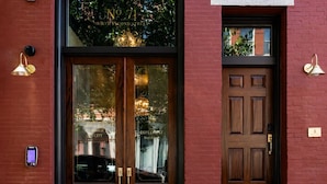 A hotel entrance with a double door, a small window, and a set of steps leading to the door. - Historic Diplomat Suite w/Parking - The Harmony (Philadelphia)