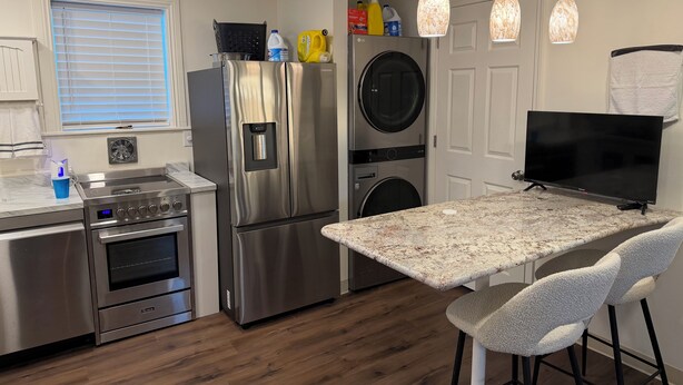 A modern kitchen with stainless steel appliances, a built-in oven, a microwave, and a granite countertop. - Perfect 2-bedroom house with AC in peaceful Jamestown w/ RV pad (Jamestown)