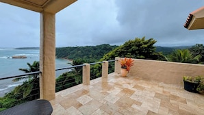 A balcony with a view of the ocean and a mountainous landscape. - Villa Vista--Luxury Private Beachfront Villa with Spectacular Views! (Calibishie)