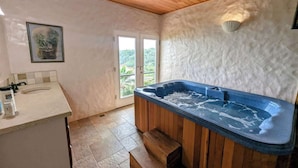 A bathroom with a bathtub, a sink, and a shower. There is a window with a view of greenery outside. - Villa Vista--Luxury Private Beachfront Villa with Spectacular Views! (Calibishie)