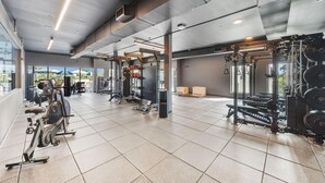 A gym with various exercise equipment, including treadmills and weightlifting stations. - Landing | Stunning 1BD, Gym, Courtyard (Houston)