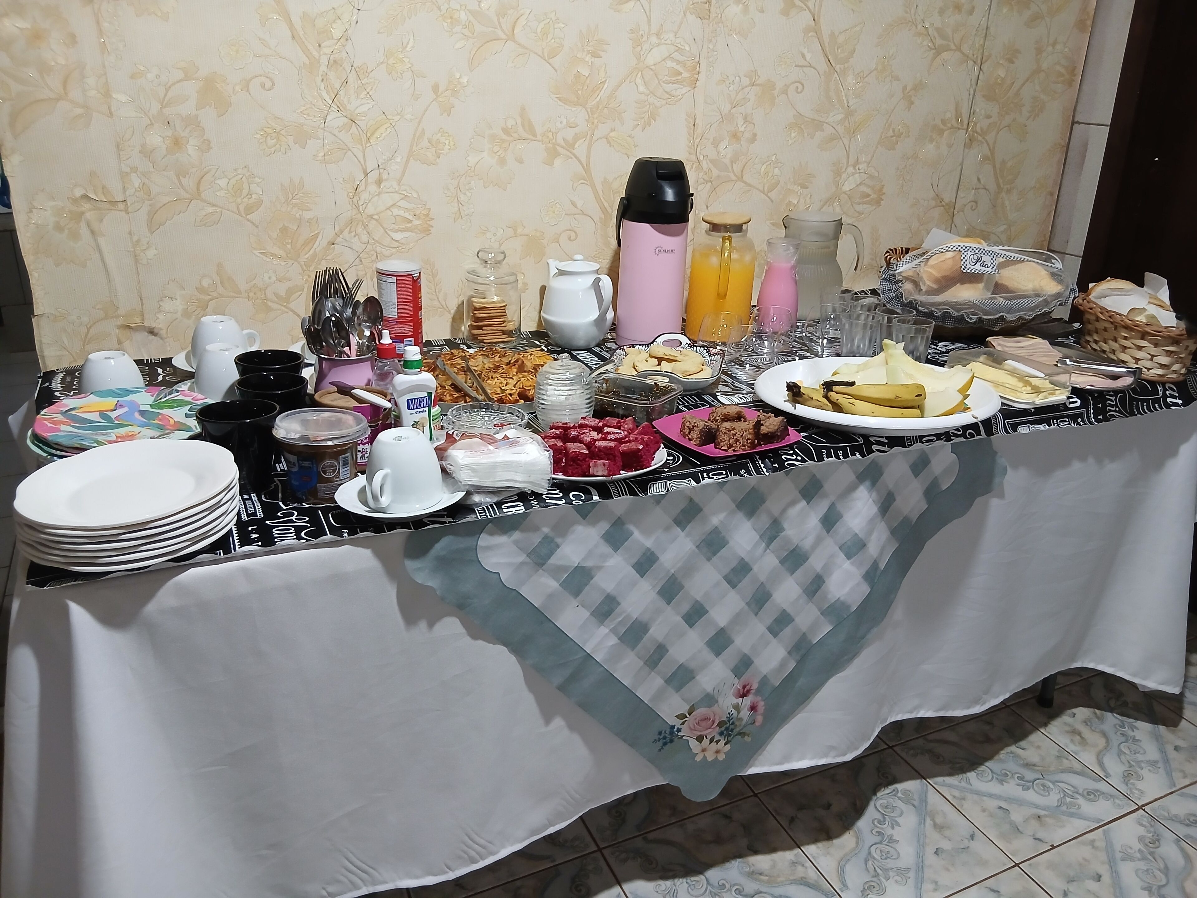 A buffet table with various food items and beverages.