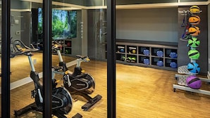 A gym with stationary bikes, a treadmill, and a variety of exercise balls. - Landing | Spectacular 2BD, Game Room, Pool (Spartanburg)