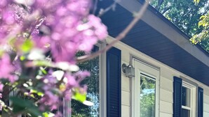 A house with a brick exterior, a white door with the number 59, and a window with black shutters. - Sleeps 8 • Pet Friendly • Near Mall of America (Saint Paul)