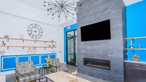 Eine moderne Lobby mit Kamin, Sitzgruppe und dekorativer Wandgestaltung.