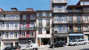 A row of multi-story buildings with balconies, storefronts, and parked cars. - VIVA Santa Catarina Serviced Apartments -3 (Porto)