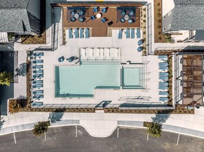 An aerial view of a hotel with a swimming pool, sun loungers, and a covered outdoor seating area. - Landing | Beautiful 1BD, Clubhouse, Pool (Nashville)