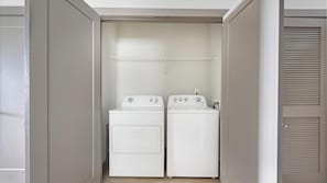 A laundry room with two white washing machines and a drying rack. - Landing | Stylish 1BD, Gym, Clubhouse (Nashville)