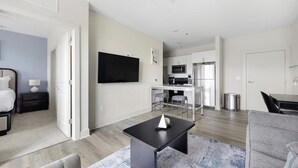 A modern apartment with a living room, kitchen, and dining area. - Landing | Incredible 1BD, Gym, Game Room (Richmond)