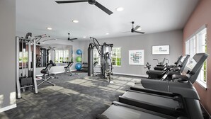 A modern gym with cardio equipment, weight machines, and exercise balls. - Landing | Chic 1BD, Gym, Pool (Palm Bay)