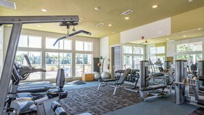A gym with treadmills, weight machines, and free weights. - Landing | Stylish 1BD, Gym (Waco)