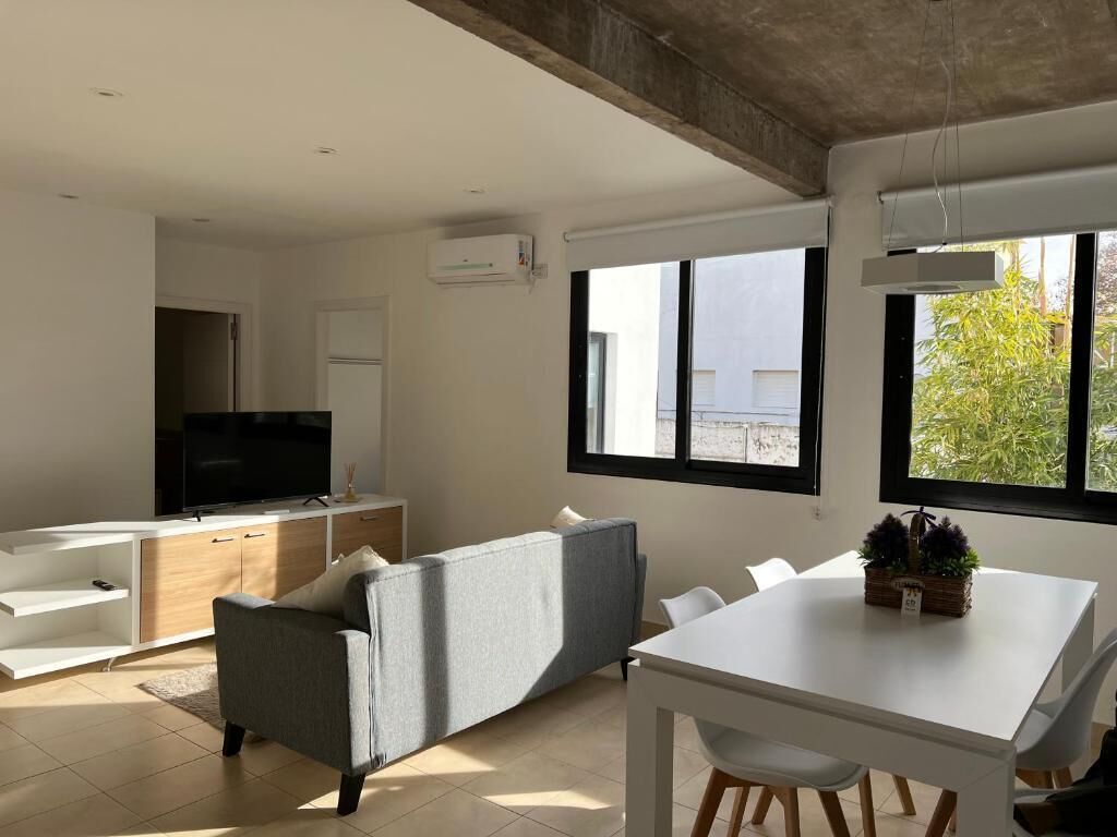 Deluxe Quadruple Room, Garden View | Living area | Flat-screen TV