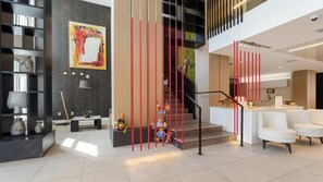 Un intérieur moderne comprenant un escalier, un coin cuisine et un espace salon.
