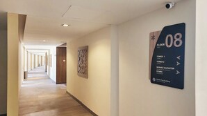 A hallway with a sign indicating 'Floor 08' and directions to 'Tower 1,' 'Tower 2,' 'Service Elevator,' and 'Stairs.' - Luxury, Family-Friendly Studio 1-0802A on the Beach! (Puerto Peñasco)