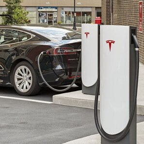 A Tesla Model 3 charging at a public station.