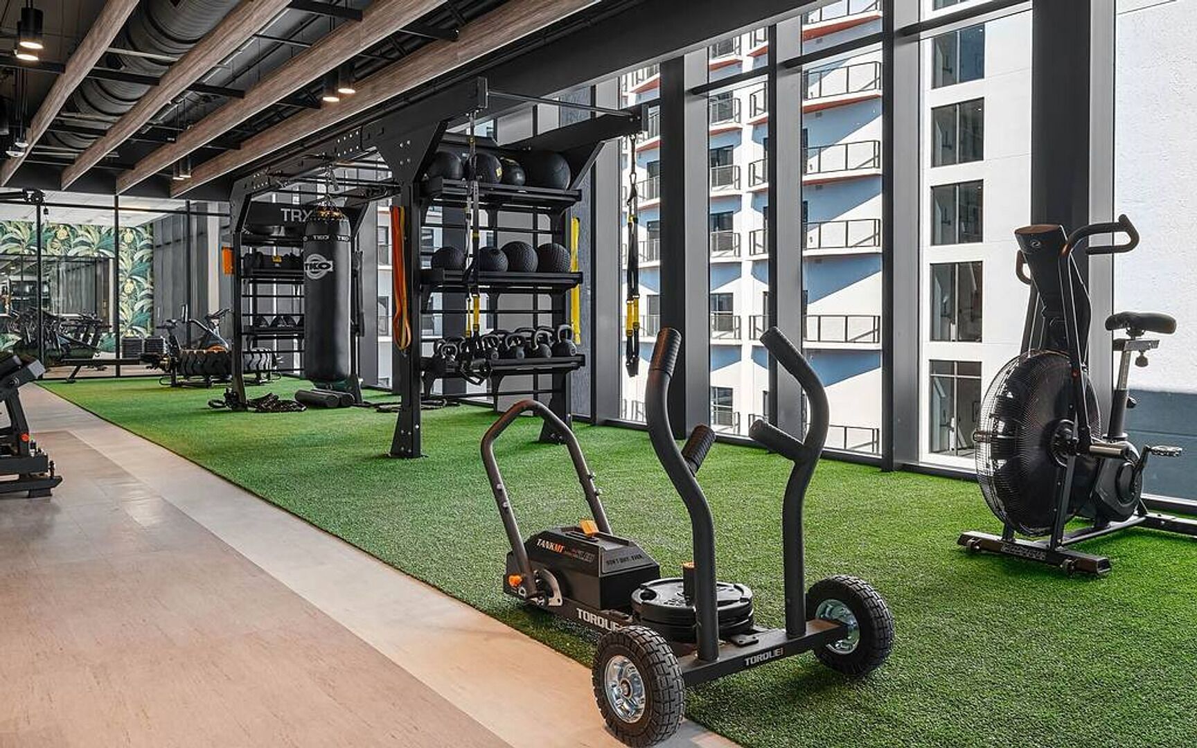 A gym with exercise equipment, a treadmill, and a stationary bike.