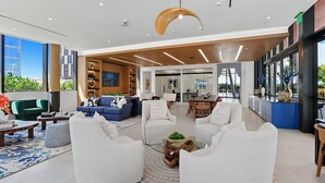 A spacious lobby with modern furniture, a dining area, and large windows offering city views. - Landing | Incredible 2BD, Pool (Miami)