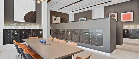 A modern conference room with a long table, chairs, and a row of filing cabinets.