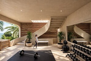 Un gimnasio moderno con diseño minimalista, que cuenta con un espejo grande, equipo de levantamiento de pesas y una banca.