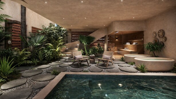 An indoor pool area with stone pathways, lounge chairs, and a spa-like setting.