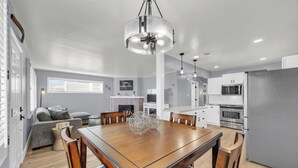 A modern kitchen with a dining table, chairs, and a chandelier. - Merry Melly, The Midtown Charmer! Close to Midtown, downtown, freeway, airport (Reno)