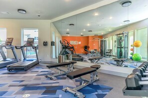 A gym with treadmills, benches, and weight machines. - Landing | Incredible 1BD in Grand Prairie (Grand Prairie)