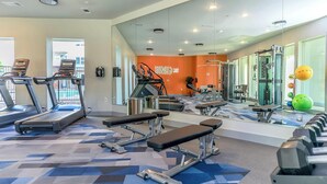 A gym with treadmills, benches, and weight machines. - Landing | Chic 2BD in Grand Prairie (Grand Prairie)