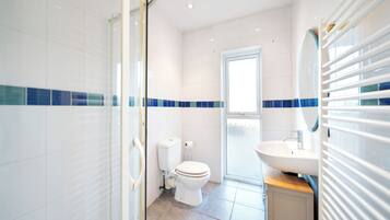 Shower, hair dryer, towels, toilet paper