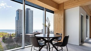 Une pièce moderne dotée d’une grande fenêtre, d’une table ronde et de quatre chaises.