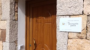 Une porte en bois avec une poignée en métal et une enseigne au-dessus.