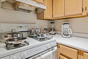 A kitchen with a white stove, pots, a blender, and a coffee maker. - Panoramic Ocean View Retreat - Family Friendly (La Mesa)