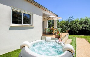 A house with a hot tub, patio furniture, and a window. - Awesome home in St Etienne de Fontbell with WiFi (St Etienne de Fontbell)