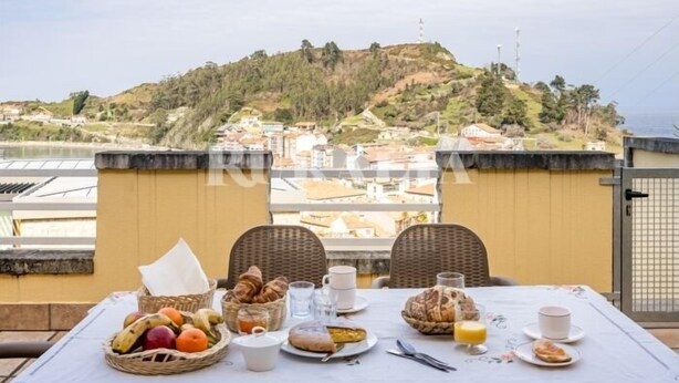 Una tavola apparecchiata per la colazione con vista su una cittadina collinare.