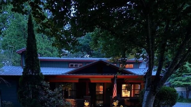 A pathway leading to a house with a red roof and an American flag. - The Bell Moon Cottage | Half a Block from Downtown (Black Mountain)